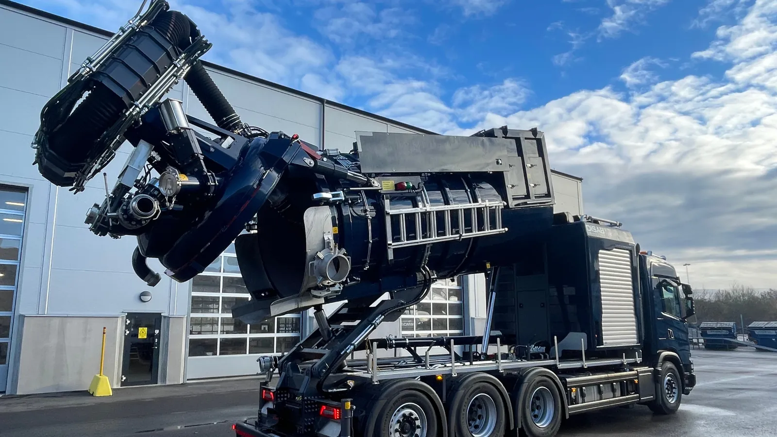DISAB heavy-duty vacuum truck with a raised suction boom, a type of unit used for mining spillage vacuum recovery